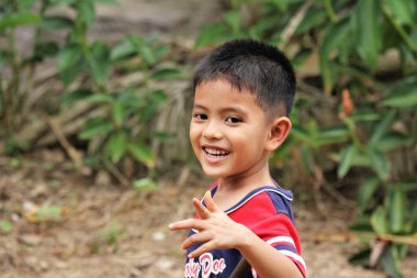Asian Thai little boy play in the backyard