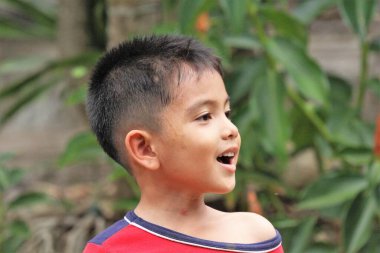 Asian Thai little boy play in the backyard