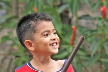 Asian Thai little boy play in the backyard
