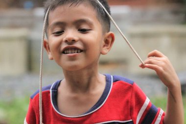 Asian Thai little boy play in the backyard
