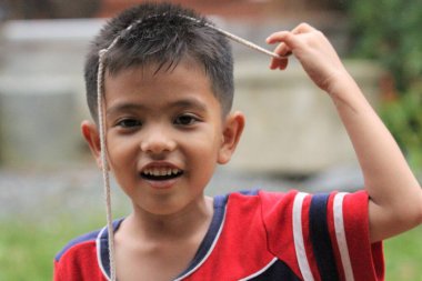 Asian Thai little boy play in the backyard