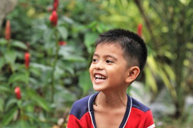 Asian Thai little boy play in the backyard