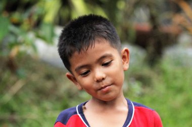 Asian Thai little boy play in the backyard