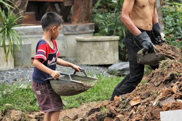 Asian Boy Pours Soil Bucket — Foto de Stock