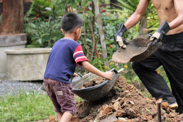 Asian Boy Pours Soil Bucket — Foto de Stock