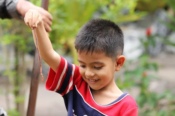 Asian Thai little boy play in the backyard
