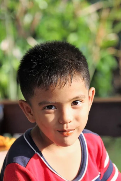 Asian Thai little boy play in the backyard