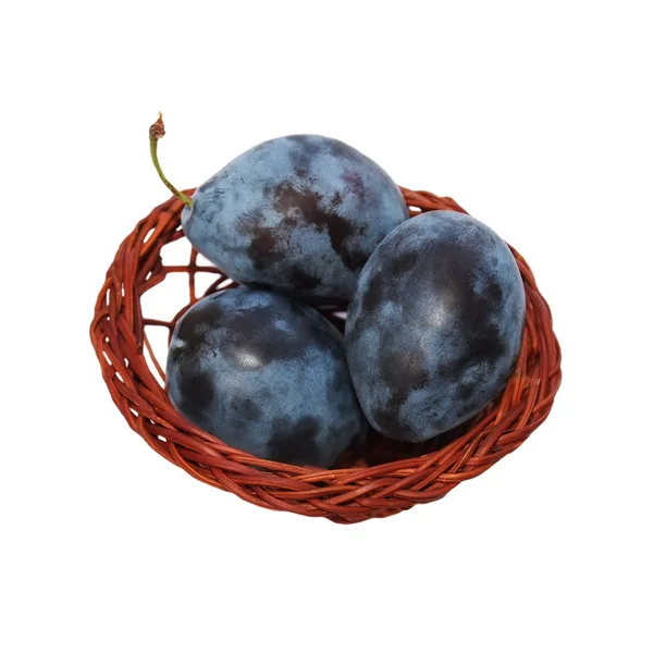 Plums with wicker baskets isolated on white background — Stock Photo, Image