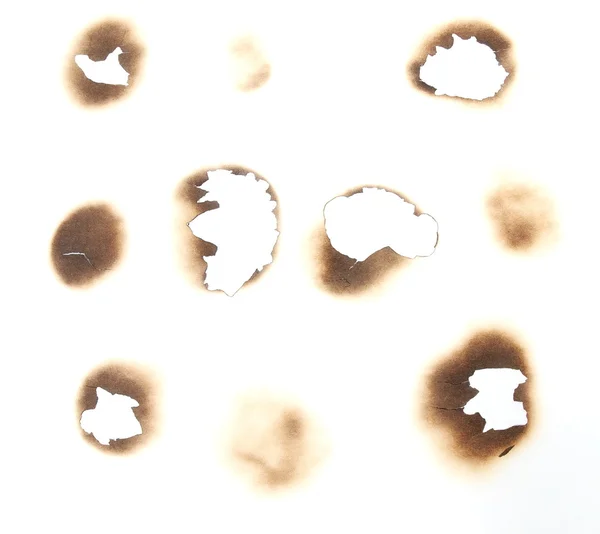 Набор сгоревших отверстий на белом фоне и текстуре — стоковое фото