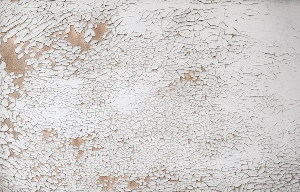 A weathered wall with cracked and peeling white paint suitable for a background texture — Stock Photo, Image