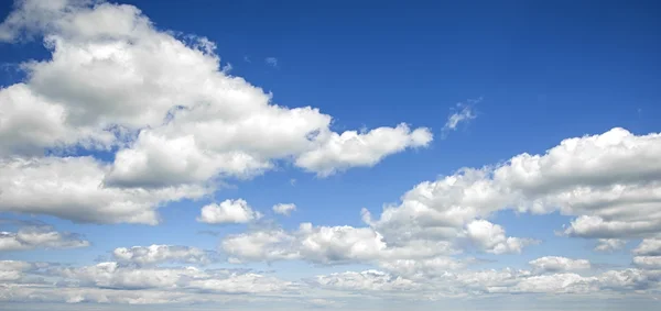 Mavi gökyüzü ile ufuk için kabarık beyaz bulutlar