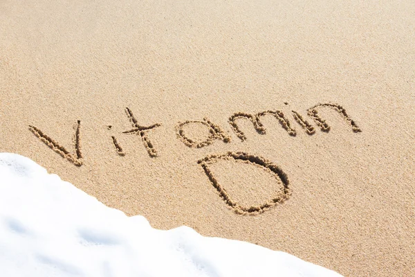 Vitamina D escrita na areia Fotos De Bancos De Imagens Sem Royalties