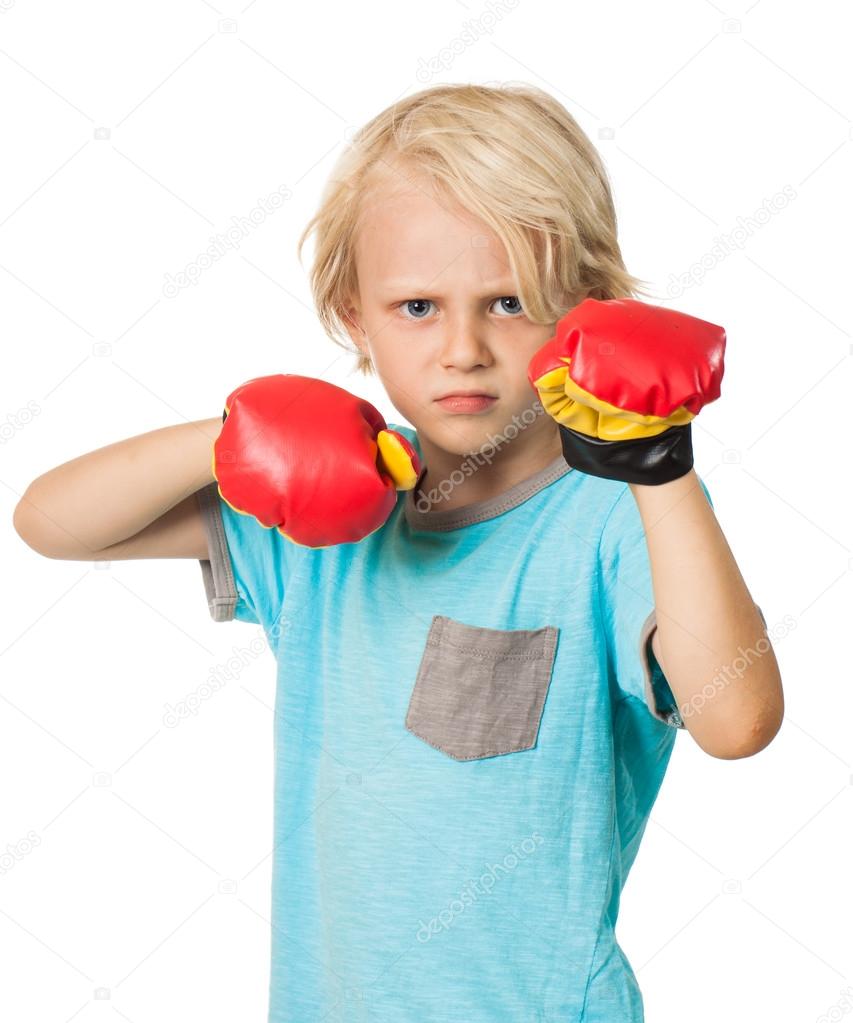 Serious angry boy with boxing gloves