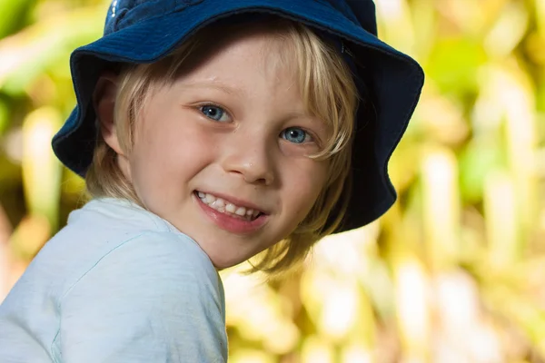 Smiling young boy lying in grass smiling — Stock Photo, Image