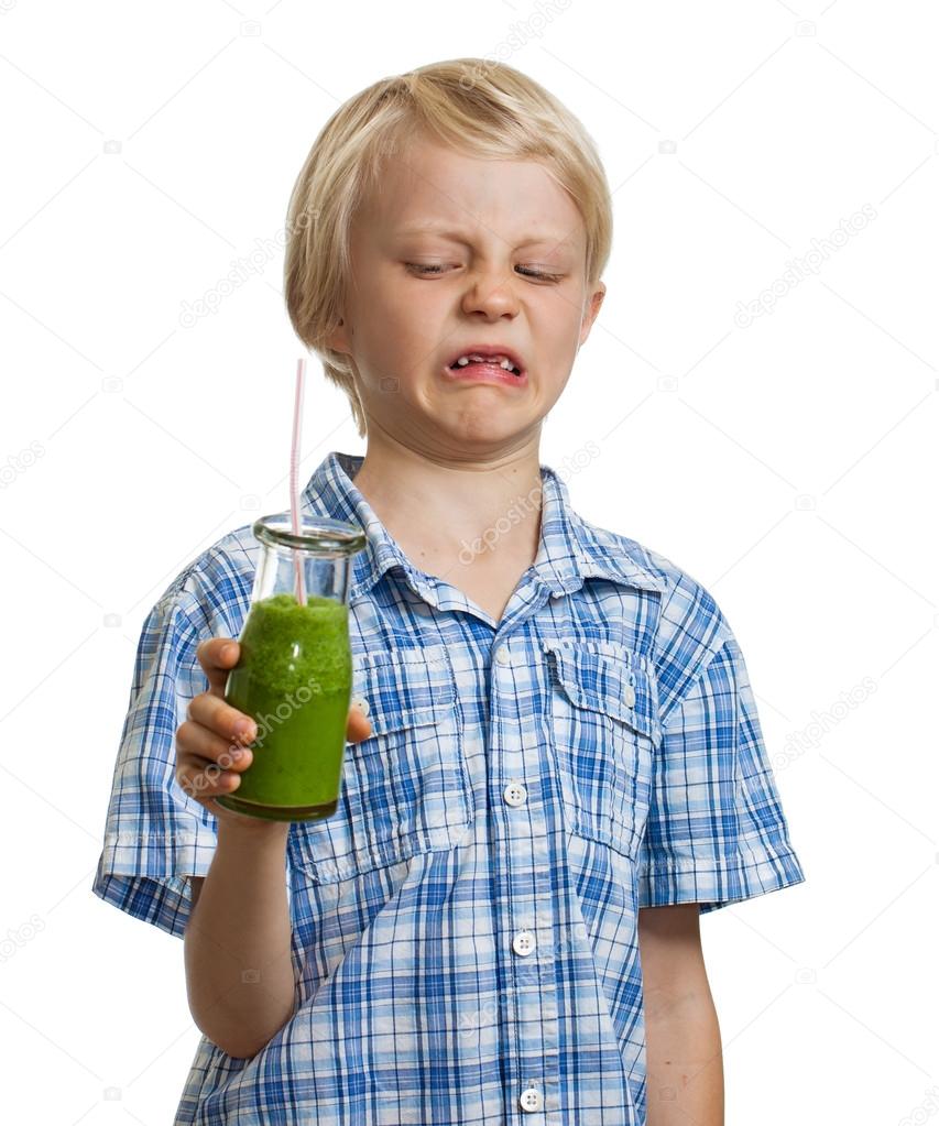 Funny boy unhappy about green smoothie