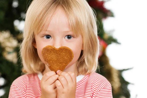 Boy smelling gingerbread cookie — Stock Photo, Image