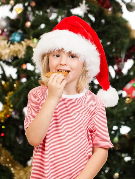 Ayudante de Santas comiendo pan de jengibre — Foto de Stock