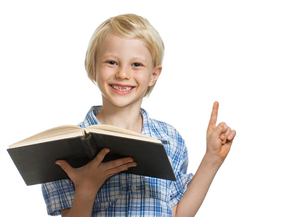 Glücklicher Junge mit Buch und Zeigefinger — Stockfoto