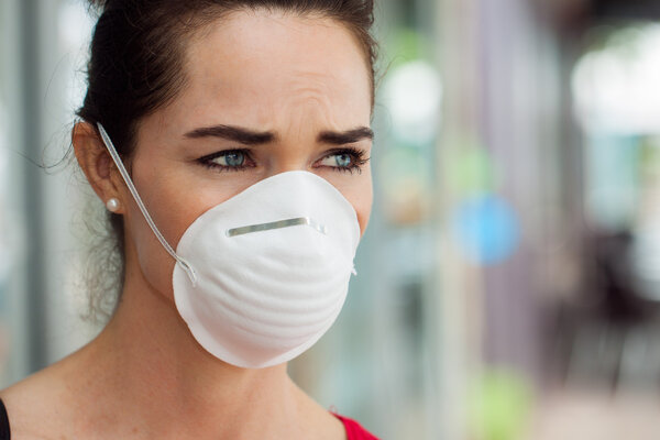 Woman wearing mask in city. Royalty Free Stock Images