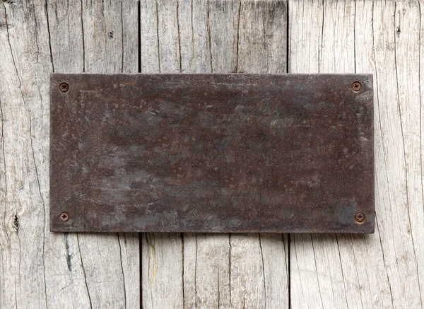 Metal sign on wood plank — Stock Photo, Image