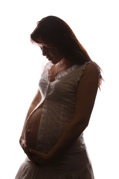 Schöne schwangere Frau. Stockbild
