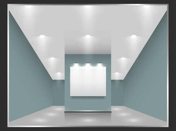 Exhibition hall with white frames on the wall, illuminated by floodlights