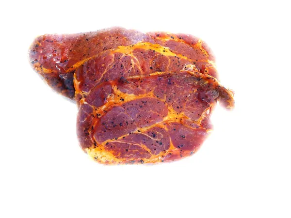 Raw meat from the pig inserted into the grill sauce — Stock Photo, Image
