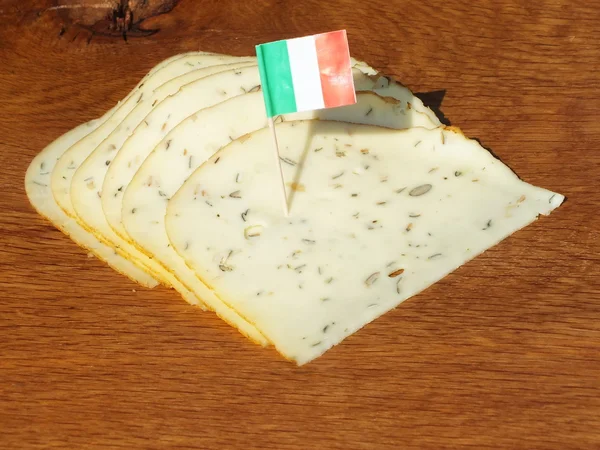 Vers gesneden plakken kaas op een eikenhouten plank — Stockfoto