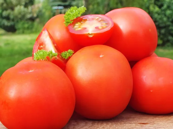 Tomatoes, cooked with herbs for the preservation on the old wooden table — Stock Photo, Image