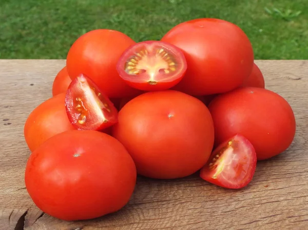 Tomatoes, cooked with herbs for the preservation on the old wooden table — Stock Photo, Image