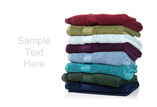 Assorted colored towels on a white background with copy space — Stock Photo, Image