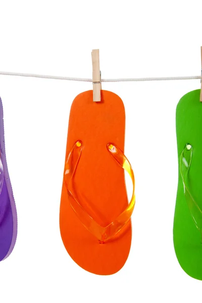 Orange flip - flop on clothesline — Stock Photo, Image