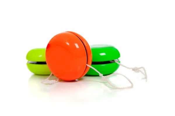 Green and red yoyos on a white background — Stock Photo, Image