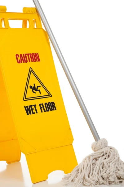 Wet floor sign and mop on white background — Stock Photo, Image