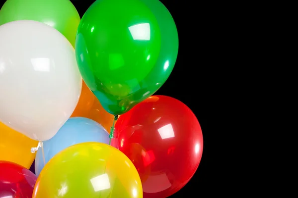 Assorted balloons on a black background — Stock Photo, Image