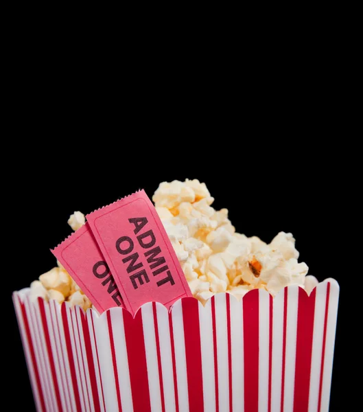 Movie ticket and popcorn on a black background — Stock Photo, Image