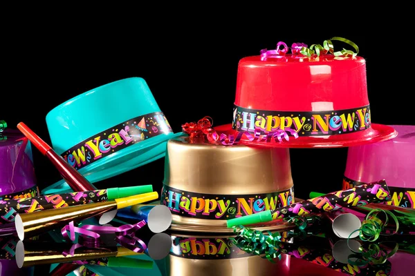 New Years' Eve party hats on black background — Stock Photo, Image