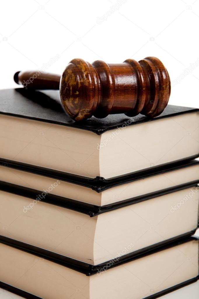 Wooden gavel on top of a stack of law books