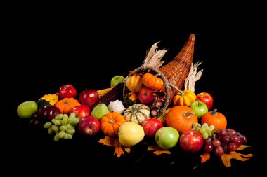 Fall arrangement of fruits and vegetables in a cornucopia clipart