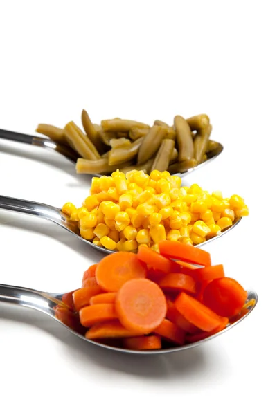 Vegetables on spoons — Stock Photo, Image