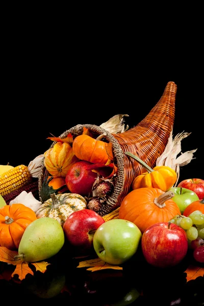 Fall arrangement of fruits and vegetables in a cornucopia Stock Image