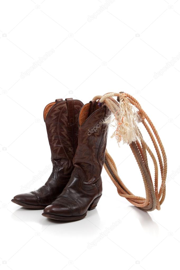 Brown leather cowboy boots on white