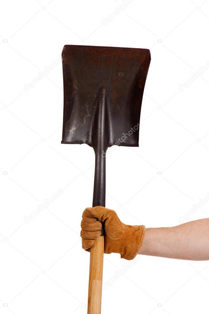 A gloved hand holding a shovel
