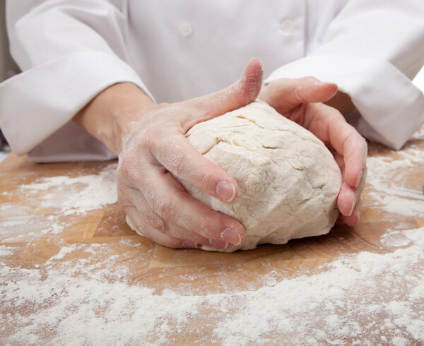 Hands kneading bread dough
