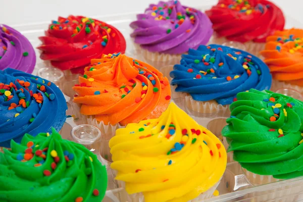 Multi-colored cupcakes with sprinkles — Stock Photo, Image