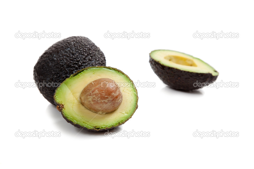 Two avocados on white