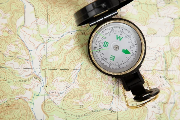 Compass laying on a map — Stock Photo, Image