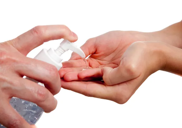 Adult giving child hand sanitizer — Stock Photo, Image