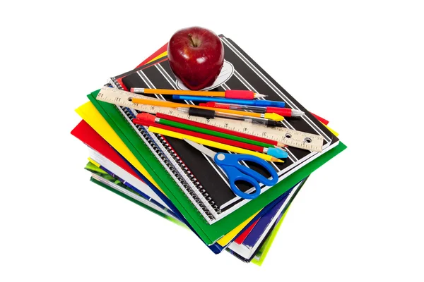 Stack of textbooks with school supplies on top — Stock Photo, Image