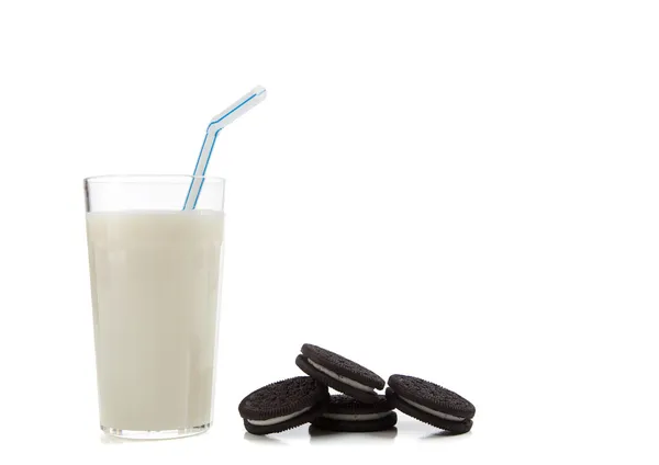 Glass of milk with cookies on white — Stock Photo, Image